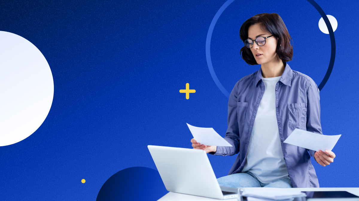 A compliance professional reviews documents alongside a laptop — illustrating the preparation RIAs and broker-dealers need before an SEC Reg S-P sweep letter arrives.